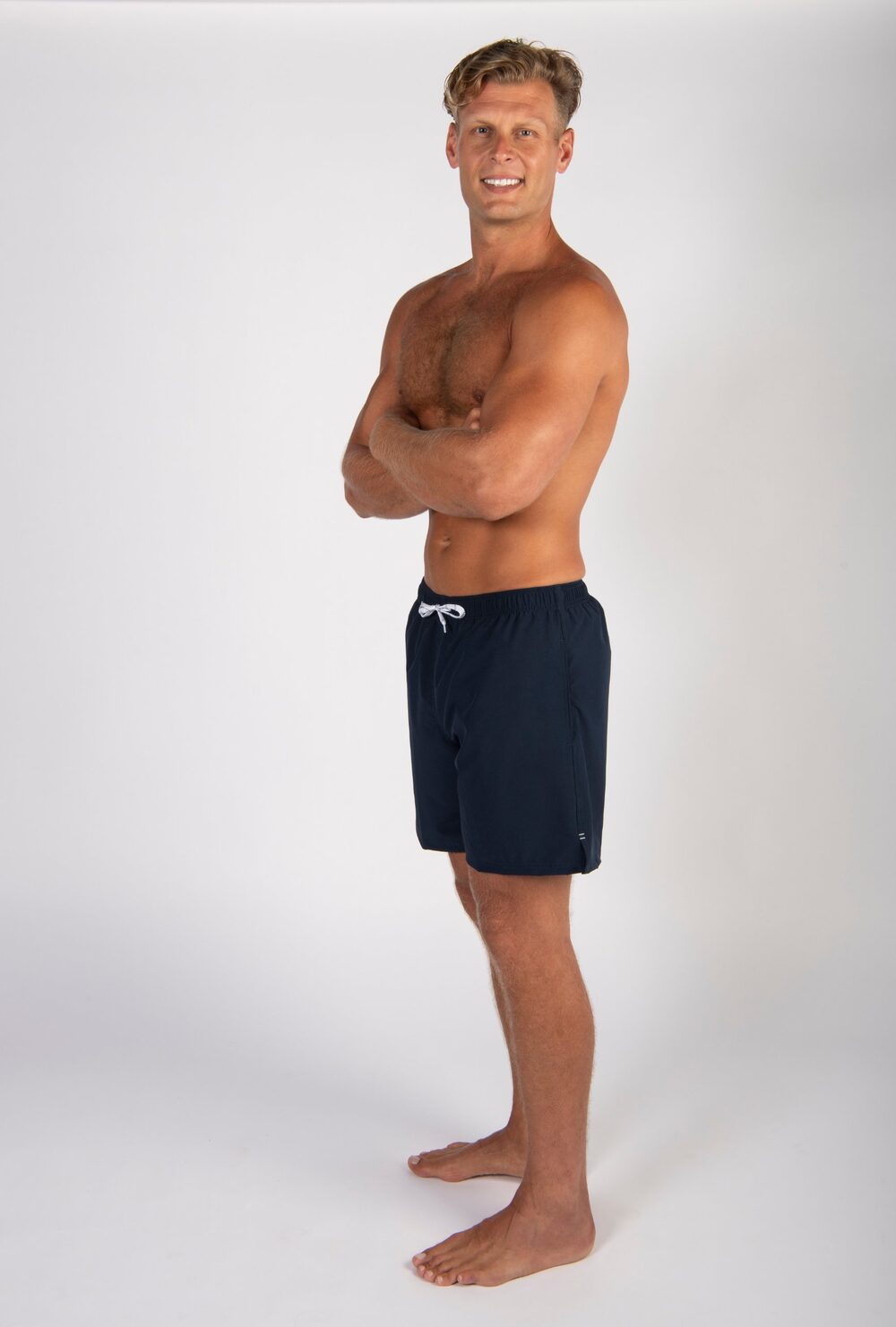Kyle modeling navy swim shorts in the studio